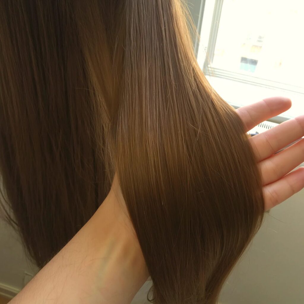 Collagen hair treatment result — glossy, smooth, healthy brown hair at Tomy B. Salon